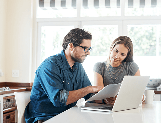 Couple looking at finances with computer