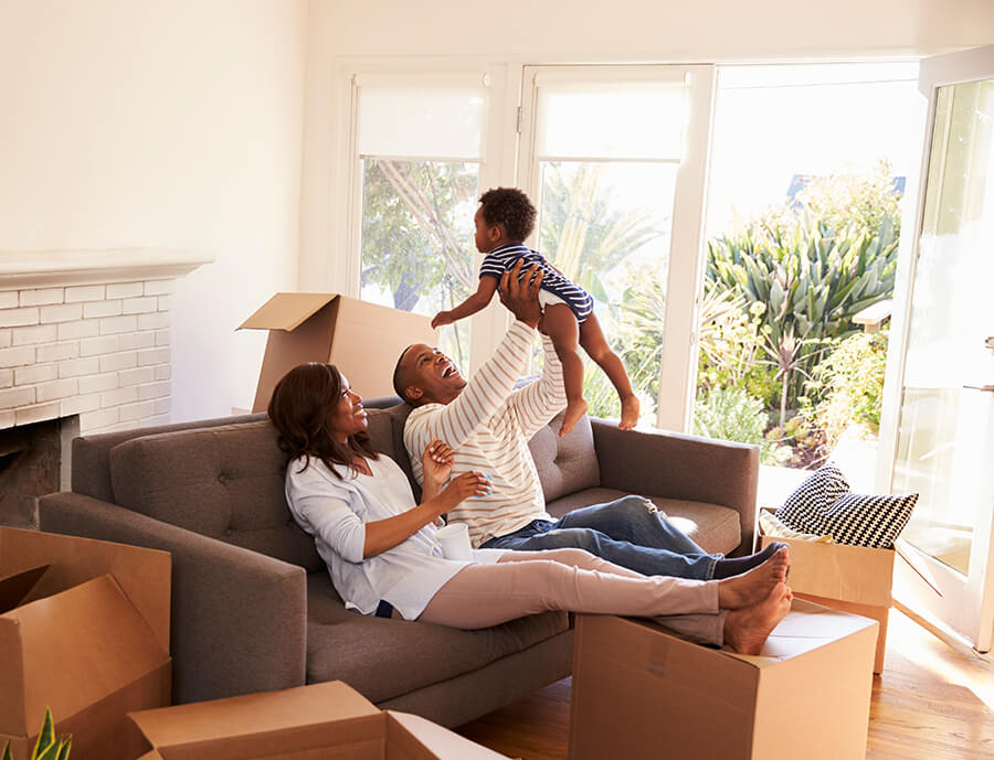 family unpacking boxes in their new home after using down payment assistance