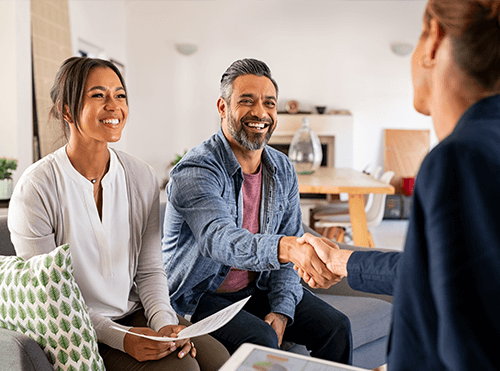 couple shaking hands with their mortgage lender